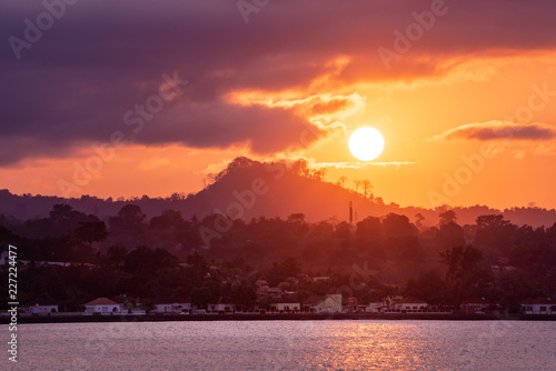 Sunset over Sao Tome Nature landscape of Sâo Tomé and Principe. Mountains like Pico Cão Grande. Travel to Sao Tome and Principe. Beautiful paradise island in Gulf of Guinea. Former colony of Portugal. photo