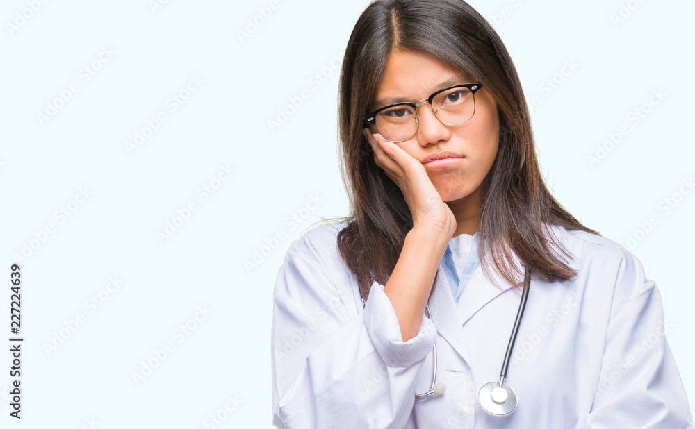 Young asian doctor woman over isolated background thinking looking tired and bored with depression problems with crossed arms. Young asian doctor woman over isolated background thinking looking tired and bored with depression problems with crossed arms.