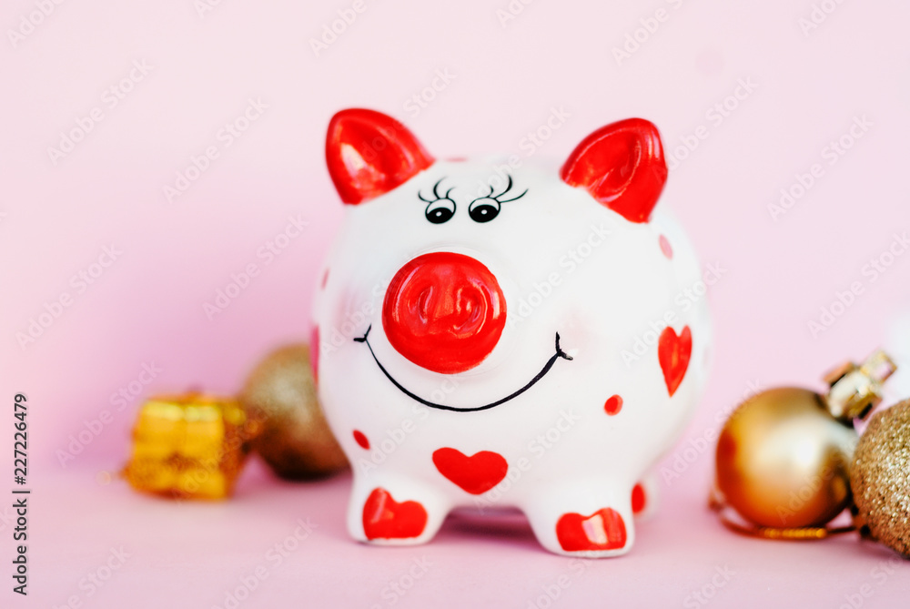 Piggy bank over pink background with christmas decoration copy space. Year of pig 2019. Piggy bank over pink background with christmas decoration copy space. Year of pig 2019.