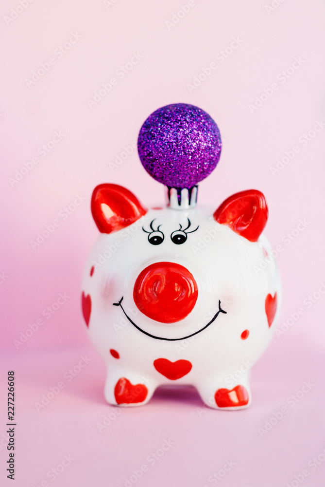 Piggy bank over pink background with christmas decoration copy space. Year of pig 2019. Piggy bank over pink background with christmas decoration copy space. Year of pig 2019.