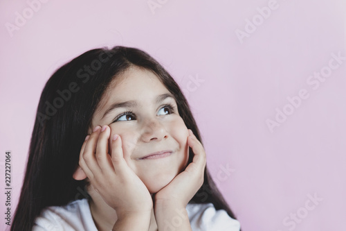 Closeup of pretty cute little girl with long hair. Beautiful kids face.