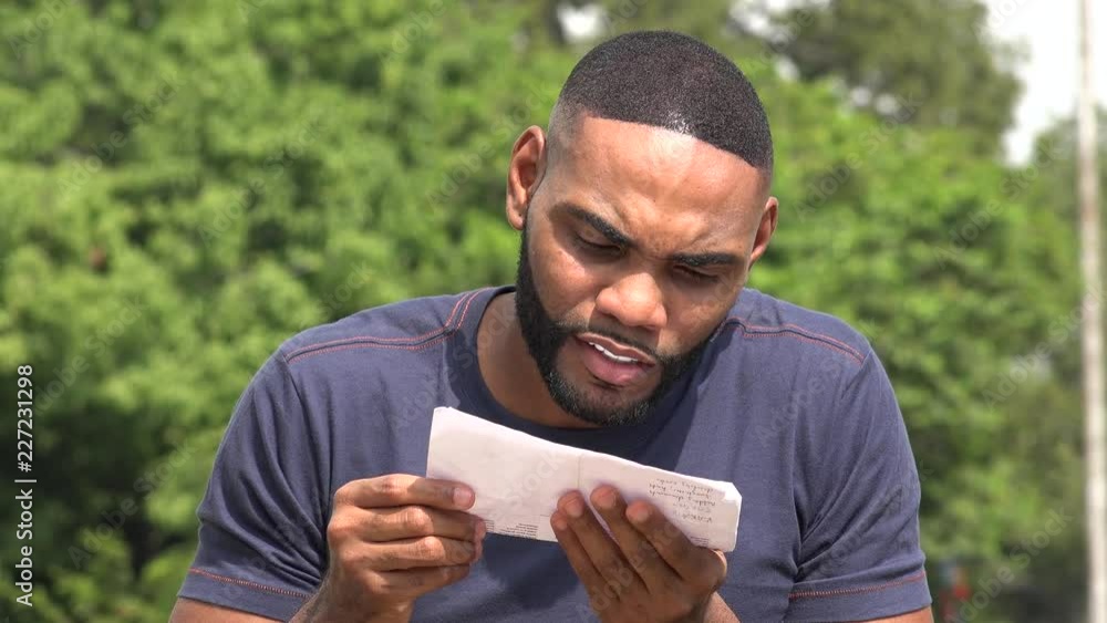 Confused Disappointed Black Man Reading A Document Confused Disappointed Black Man Reading A Document