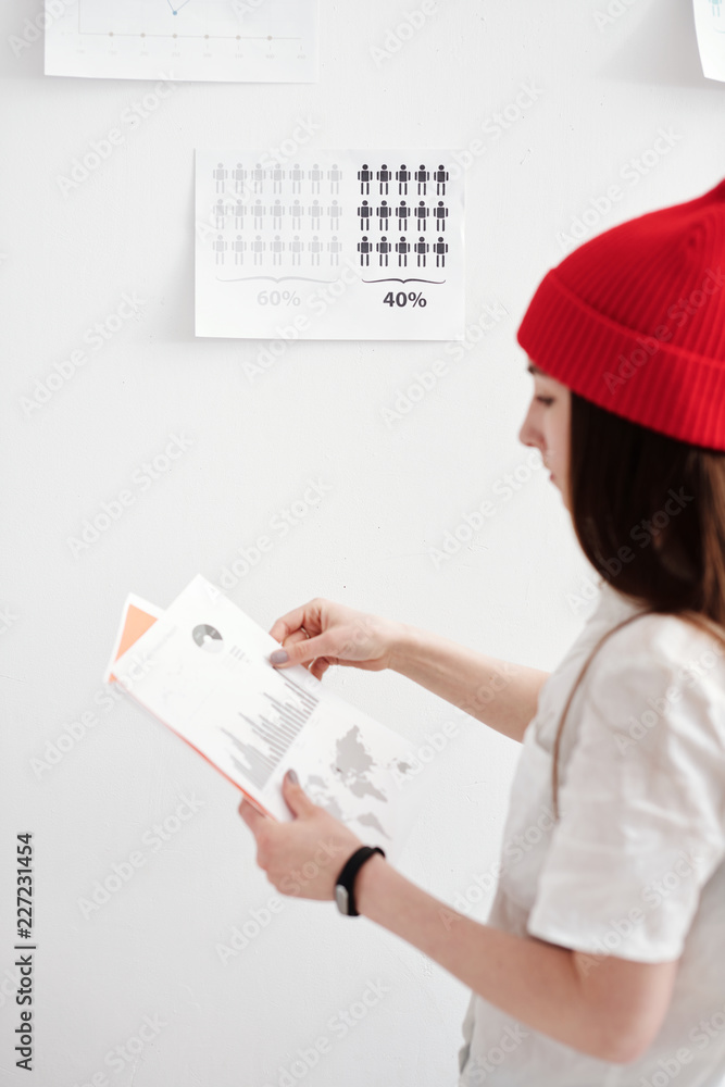 Young freelance designer working on creating infographics Young freelance designer working on creating infographics