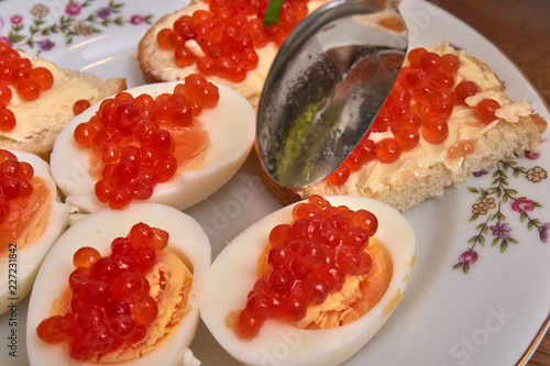 eggs with red caviar on a white plate