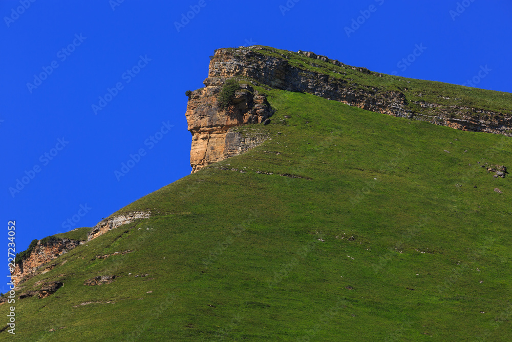 Stone ledge of a rocky ridge against the blue sky. Stone ledge of a rocky ridge against the blue sky.