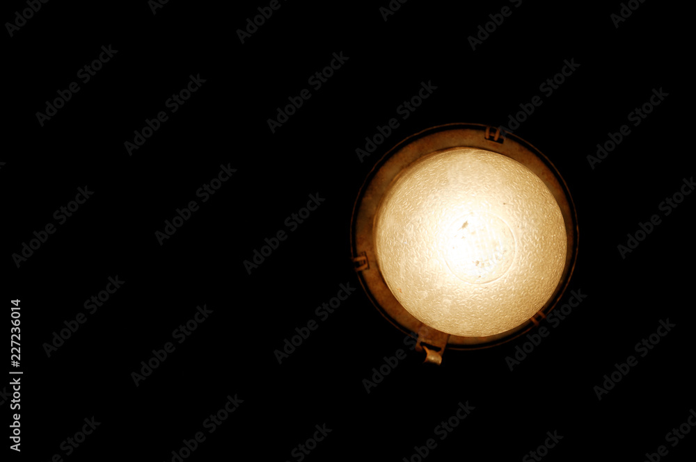 Lamp at black background. light bulb in the dark. Waterproof lamp for sauna. retro design style decoration Lamp at black background. light bulb in the dark. Waterproof lamp for sauna. retro design style decoration