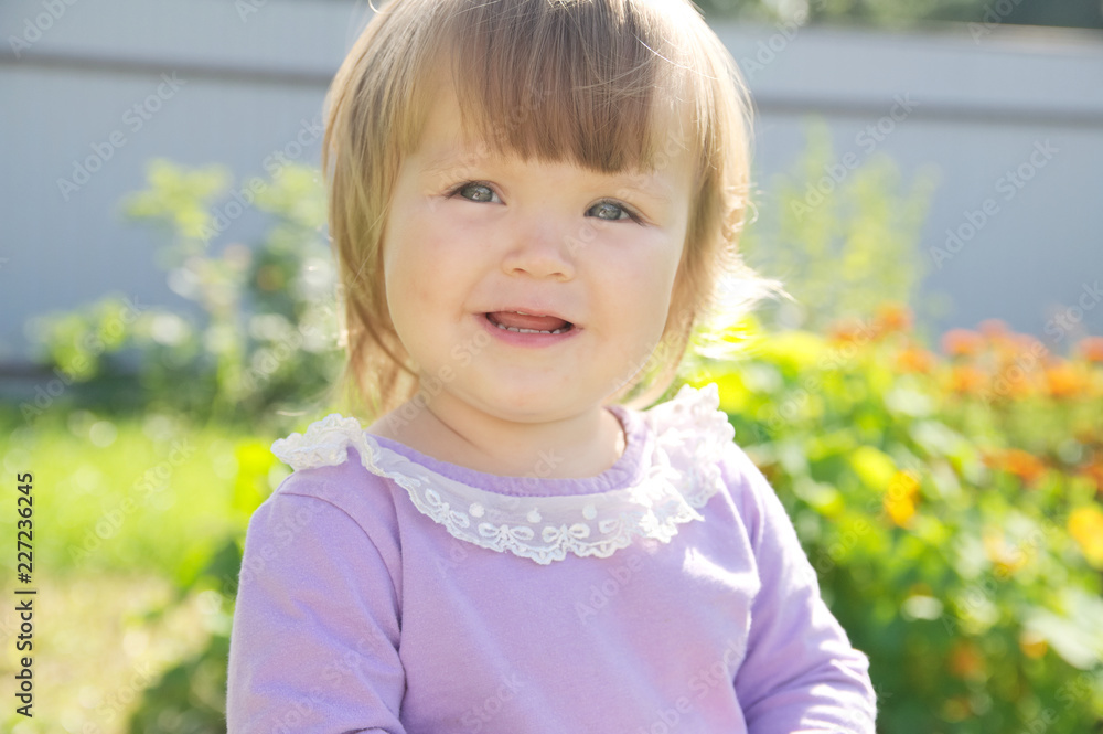 Cute baby girl happy smiling portrait. Adorable emotional child outdoor in park Cute baby girl happy smiling portrait. Adorable emotional child outdoor in park
