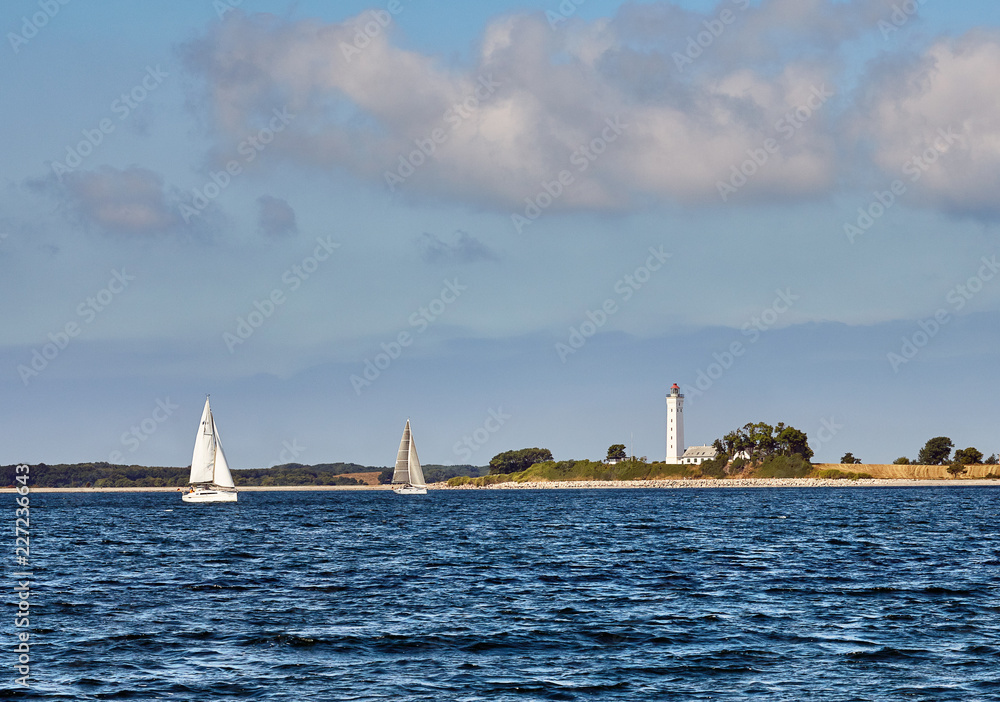 Keldsnor lighthouse and sailing yachts on a sunny day