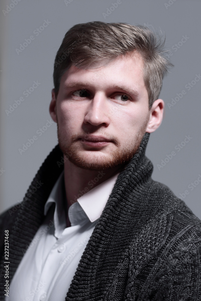 Obraz premium close up.a stylish young man in a cardigan.isolated on grey background