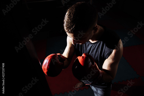Boxer training on a punching bag in the gym.