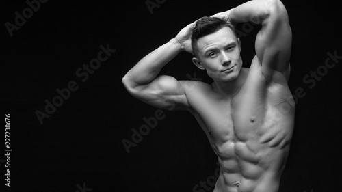 Isolated black and white muscle man with a perfect abs.
