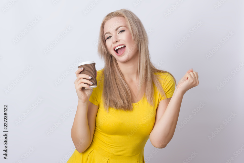 Blonde woman holding coffee cup in her hands Blonde woman holding coffee cup in her hands