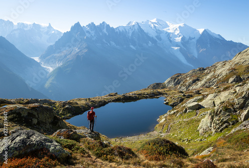 Hiker looking at Lac des Cheserys on the famour Tour du Mont Blanc near Chamonix, France.