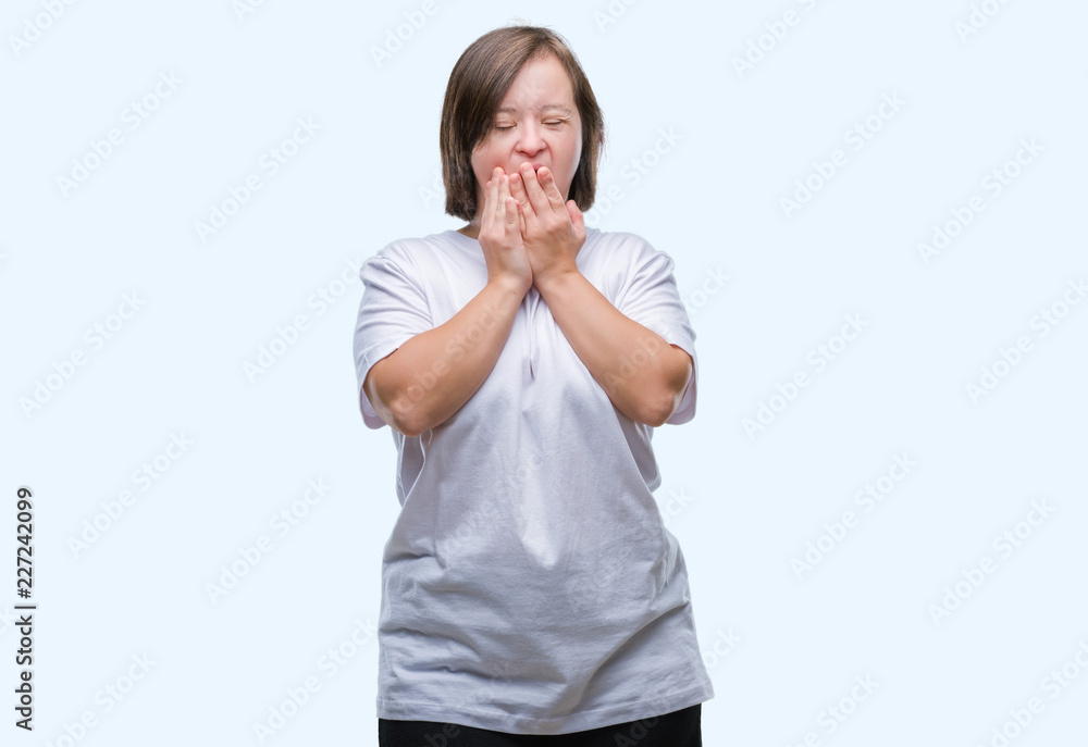 Young adult woman with down syndrome over isolated background bored yawning tired covering mouth with hand. Restless and sleepiness. Young adult woman with down syndrome over isolated background bored yawning tired covering mouth with hand. Restless and sleepiness.