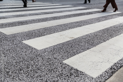road surface marking and traffic concept - close up of crosswalk