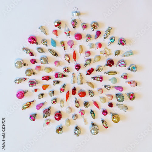 Many colorful new year toys lying on white background in shape of Christmas bauble, top view, flat lay. Creative composition, winter holiday concept, greeting card, square © Tatyana_Andreyeva