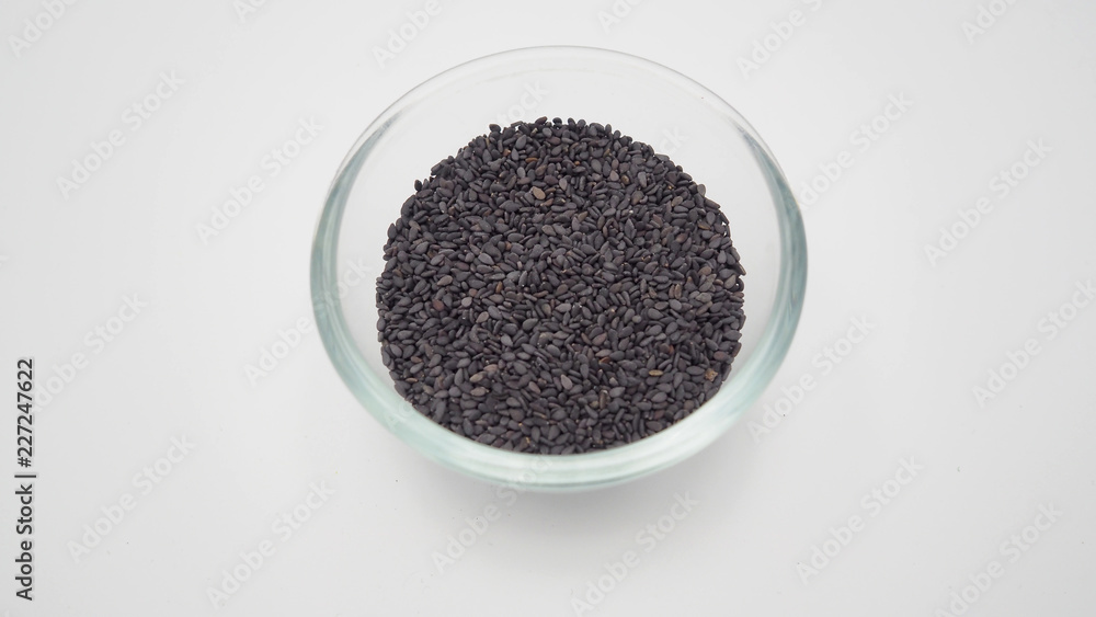 Black sesame seeds are so nutritious in bowl on white background. Black sesame seeds are so nutritious in bowl on white background.