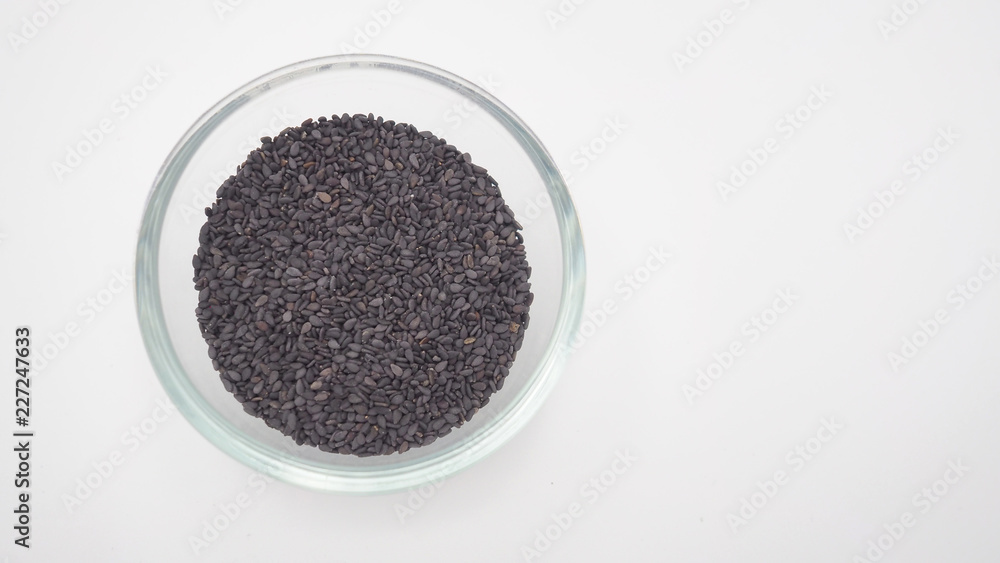 Black sesame seeds are so nutritious in bowl on white background. Black sesame seeds are so nutritious in bowl on white background.