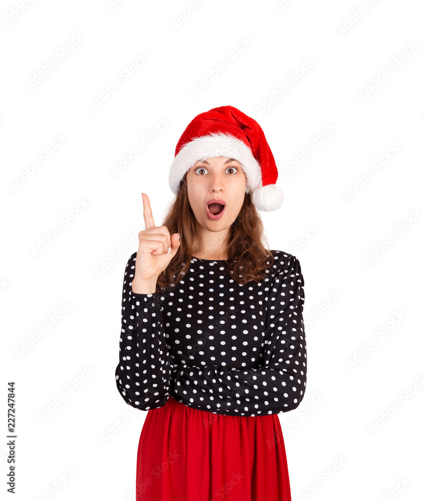 Portrait of woman raising index finger and standing with opened mouth, having suggestion. emotional girl in santa claus christmas hat isolated on white background. holiday concept Portrait of woman raising index finger and standing with opened mouth, having suggestion. emotional girl in santa claus christmas hat isolated on white background. holiday concept