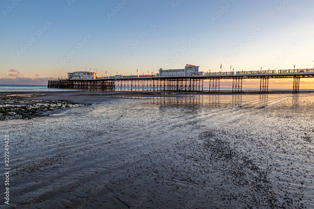 Worthing Pier in Sussex, at low tide during sunset Worthing Pier in Sussex, at low tide during sunset