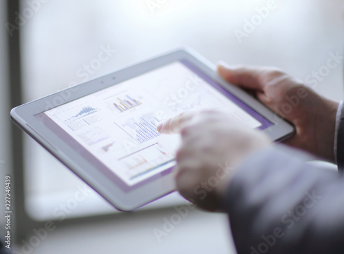 close up.businessman analyzing financial data using digital tablet