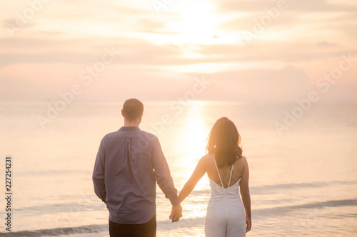 love couple enjoying the sunset on beach