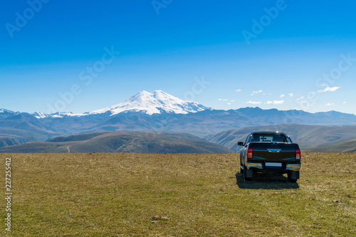 Pick up car at beautifull landscape view of Caucasus mountains near mount Elbrus - the highest mountain in Europe.