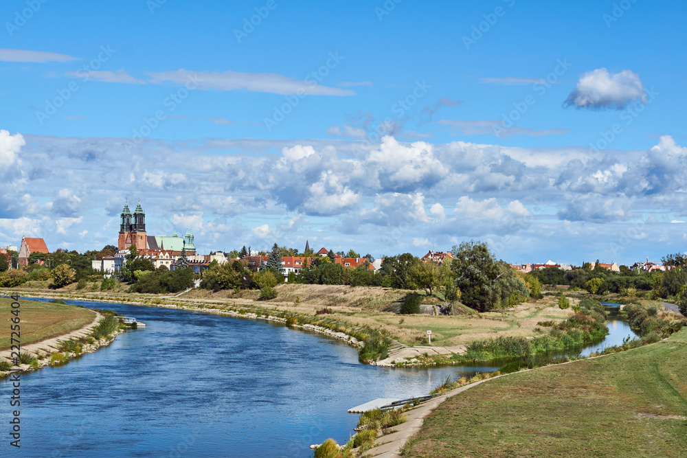 Urban landscape with river Warta and the cathedral towers  in Poznan.