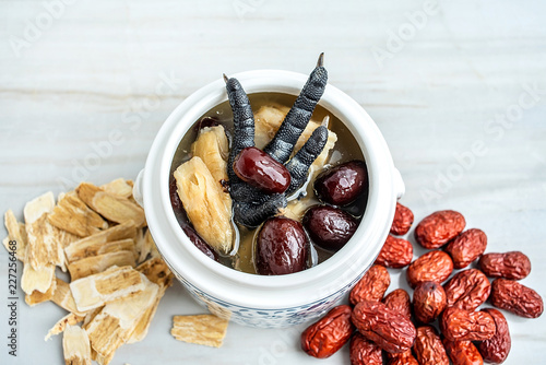 Chinese health soup - Huangqi red dates stewed black chicken photo