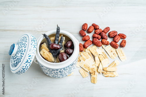 Chinese health soup - Huangqi red dates stewed black chicken photo