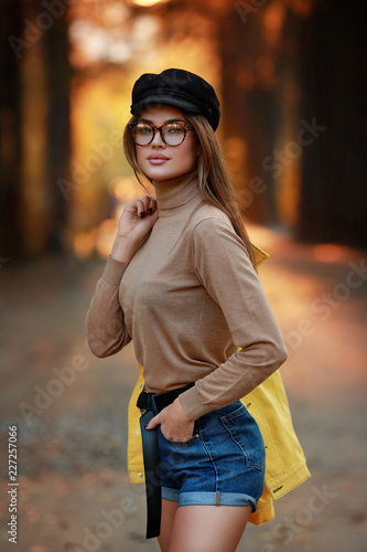 Young female brunette model in autumn park