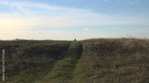 Wallpaper Mural lonely man goes and looks, landscape in hilly terrain. Torontodigital.ca