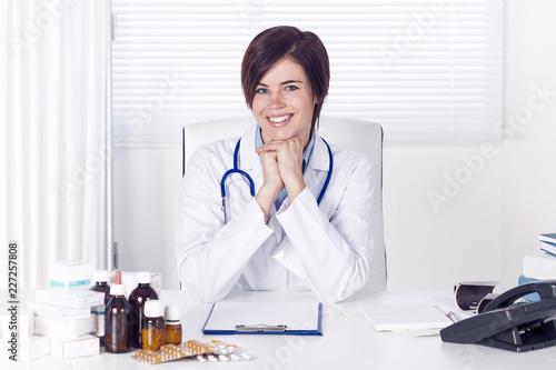 Smiling young female doctor in her office