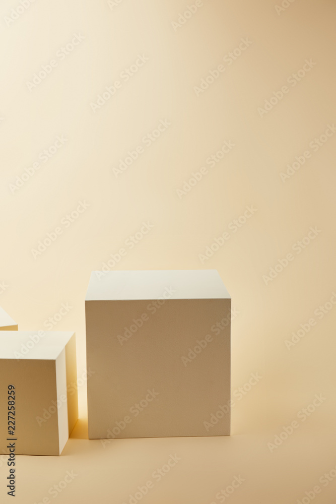 cubes in various sizes on beige surface cubes in various sizes on beige surface