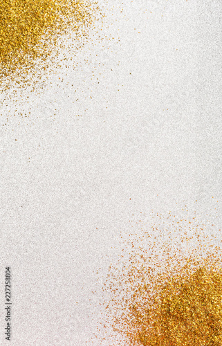 Silver background with gold glitter in the corners.