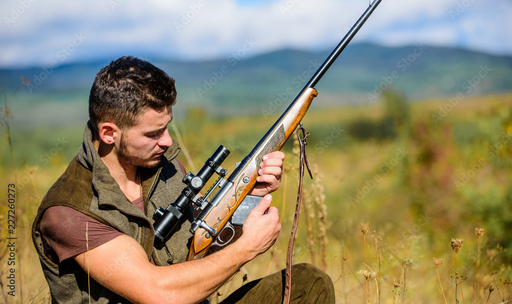 Man charging hunting rifle. Hunting equipment concept. Hunter khaki clothes  ready to hunt nature background. Hunting shooting trophy. Hunter with rifle  looking for animal. Hunting hobby and leisure Stock Photo | Adobe