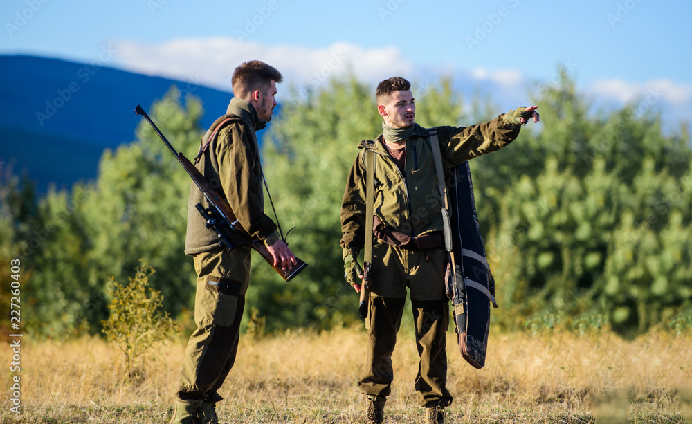 Gamekeepers sunny fall day. Hunting with partner provide greater safety fun and rewarding. Gamekeeper rifles nature environment. Gamekeepers walk mountains background. Gamekeeper occupation concept Gamekeepers sunny fall day. Hunting with partner provide greater safety fun and rewarding. Gamekeeper rifles nature environment. Gamekeepers walk mountains background. Gamekeeper occupation concept