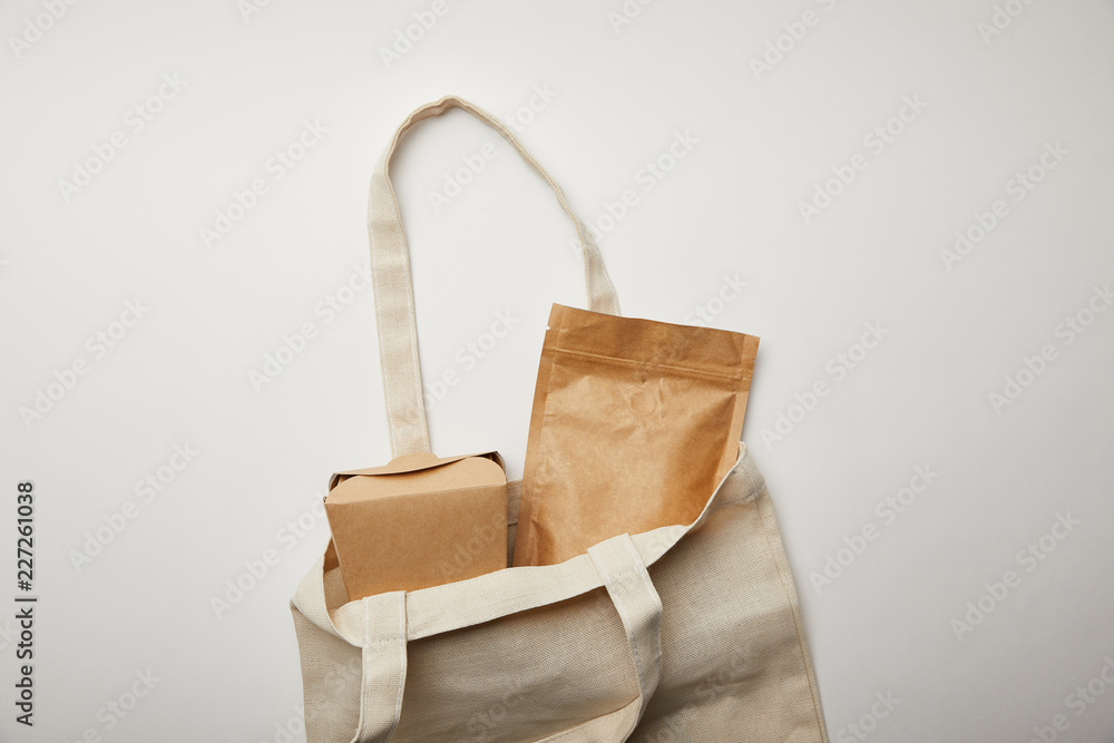top view of cotton bag with cardboard noodle box on white surface top view of cotton bag with cardboard noodle box on white surface