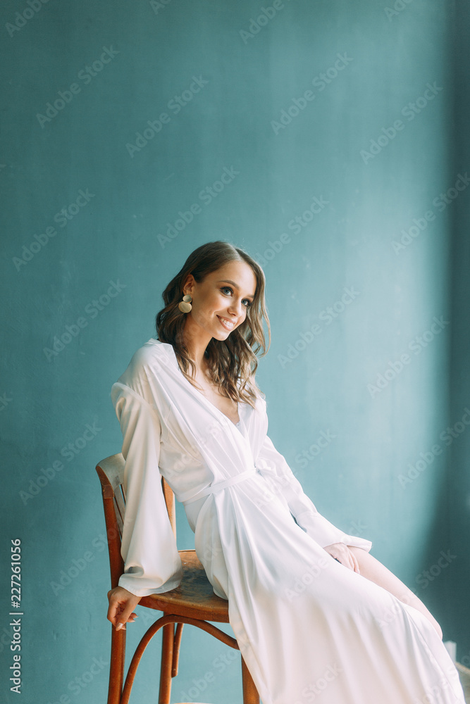 Conceptual wedding, the morning of the bride in the European style. Boudoir dress and a bouquet of flowers, fees in the interior Studio. Conceptual wedding, the morning of the bride in the European style. Boudoir dress and a bouquet of flowers, fees in the interior Studio.