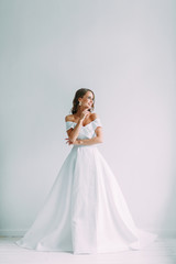 A concept wedding, contemporary European bride. Bouquet of flowers, fees in the interior Studio. Ideas for a minimalist wedding, white color