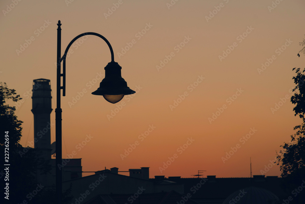 Obraz premium Sunset over city roofs.