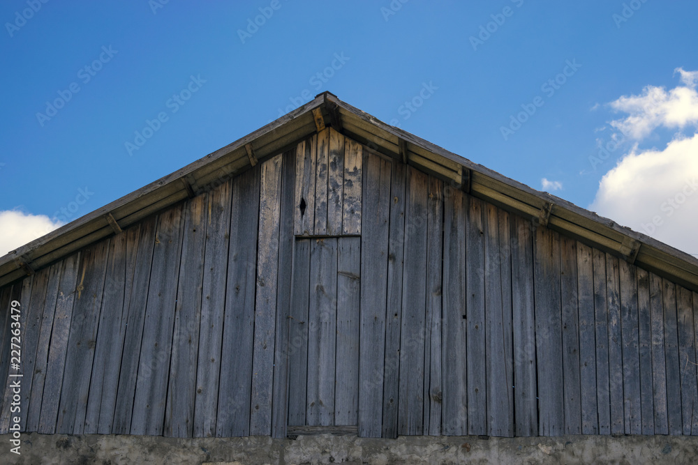 Old farm roof and blue sky
