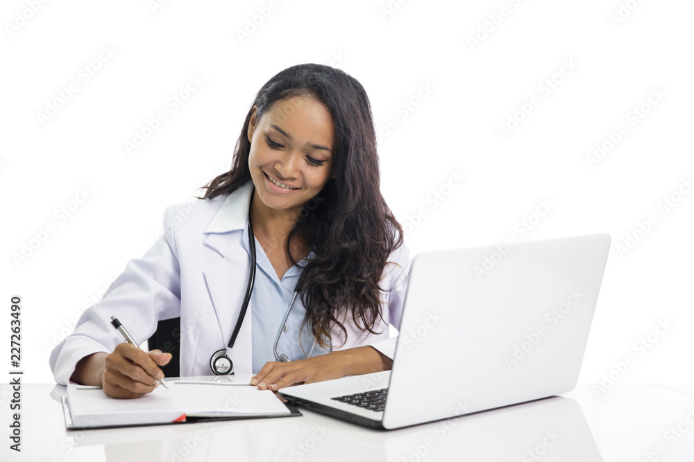 beautiful young doctor working on her laptop and writing on note beautiful young doctor working on her laptop and writing on note