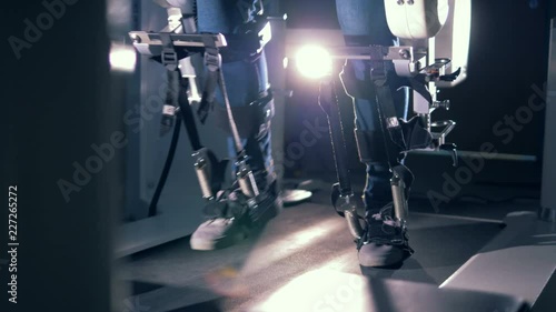 Patient using orthopaedic equipment. One man walks on a special track in medical prosthesis. photo