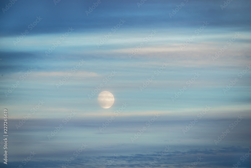 Full moon in the sky with interesting stripes of clouds. Abstraction.
Full moon in the sky with interesting stripes of clouds. Abstraction.
