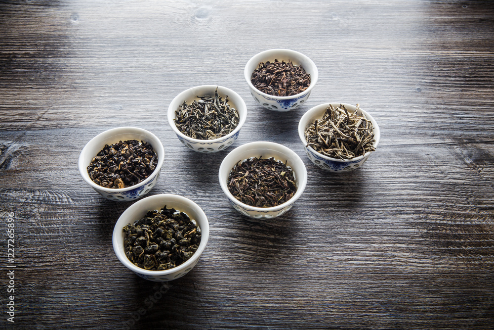 assorted tea leaves in six white small round vessels assorted tea leaves in six white small round vessels