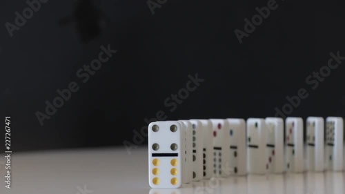 Dominos falling towards camera