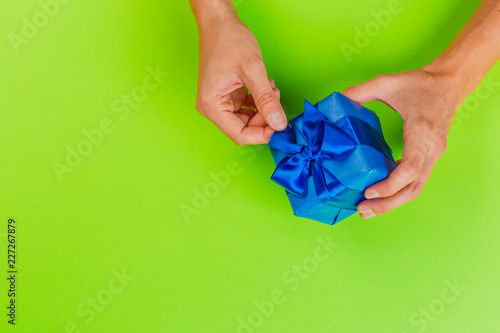 Wallpaper Mural Woman holding gift box on color background Torontodigital.ca