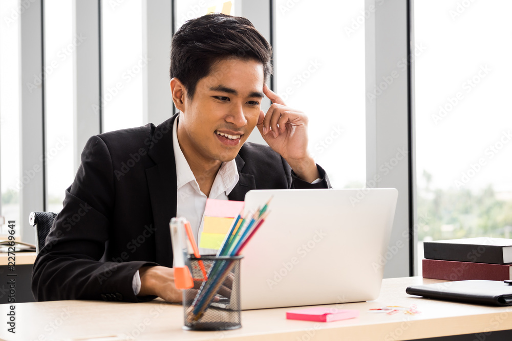 Happy Businessman is working at the office. Happy Businessman is working at the office.