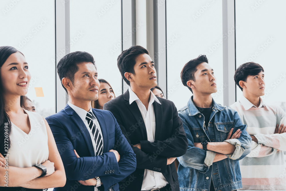 Asian Businesspeople are standing up and smiling at the office. Asian Businesspeople are standing up and smiling at the office.